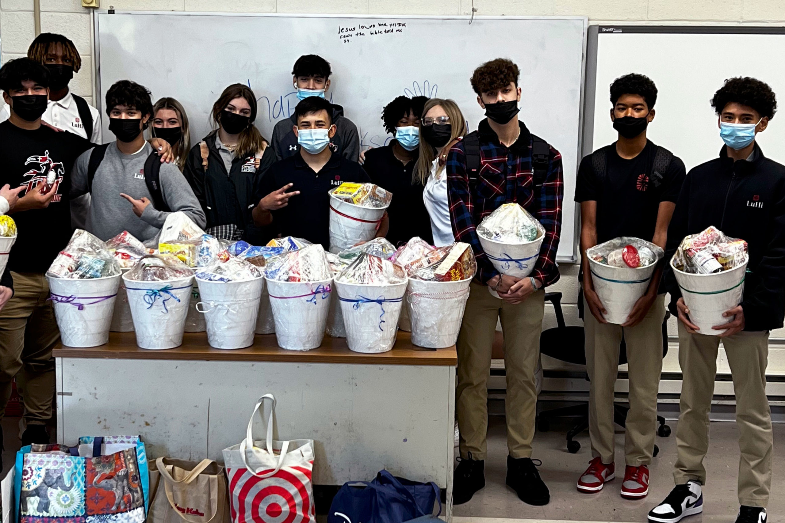 Students posing with Thanksgiving baskets