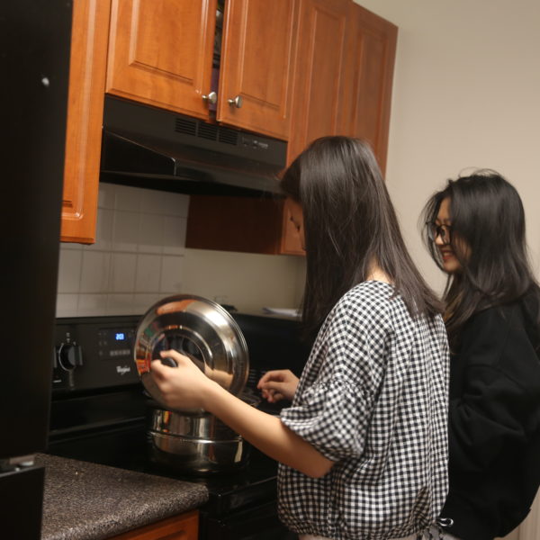 International students cooking in their dorm