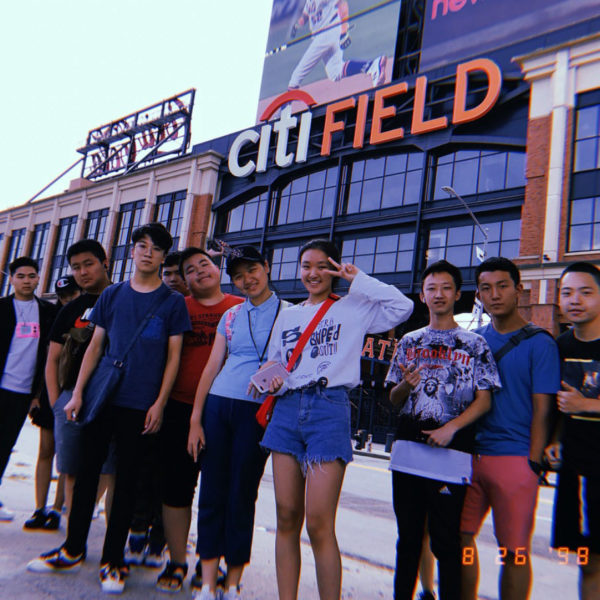 Group of international students standing in front of Citi Field before a Mets game