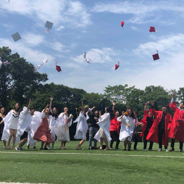 International students throwing their caps at graduation