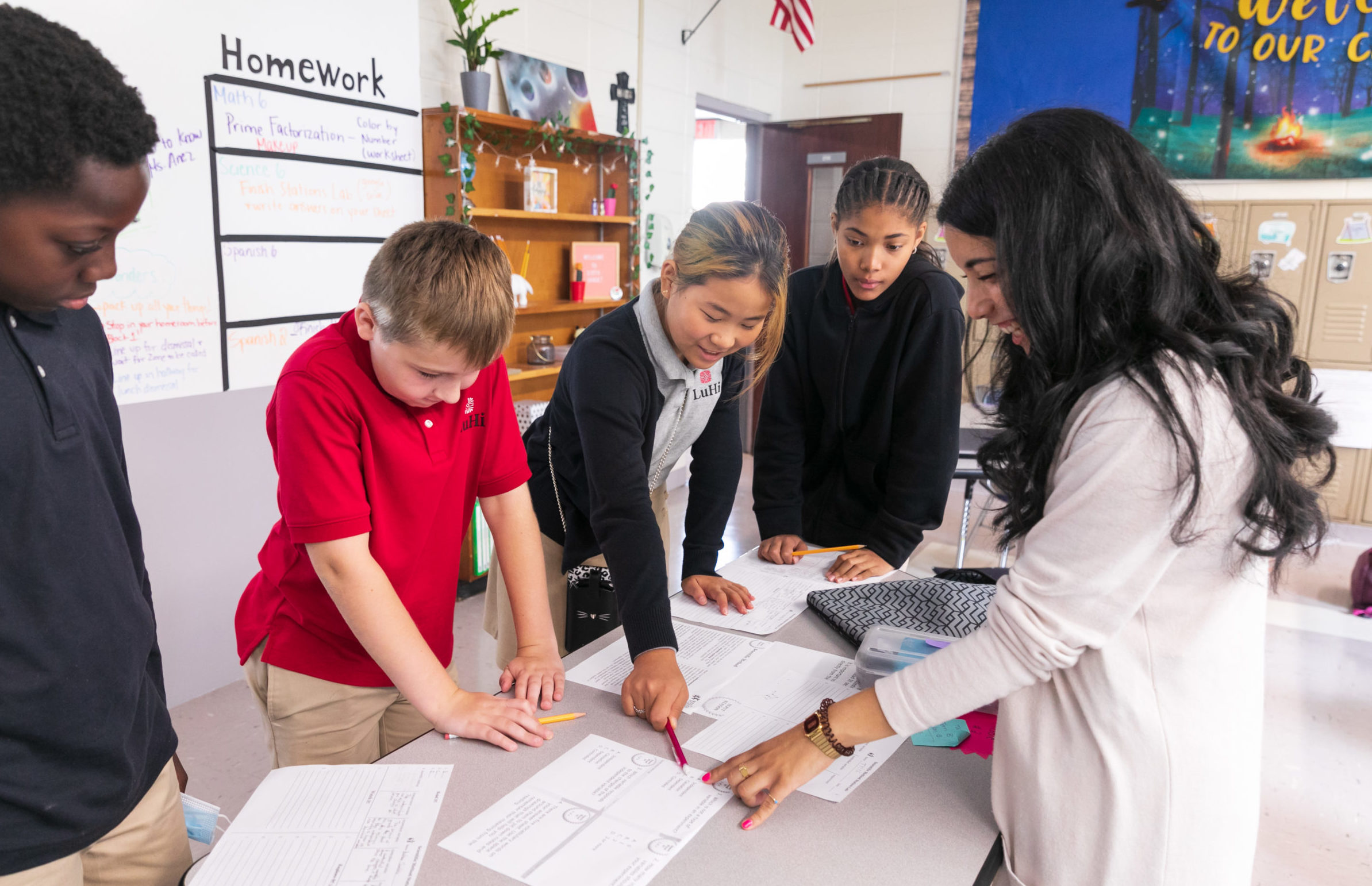 6th grade teacher talking to students in a group