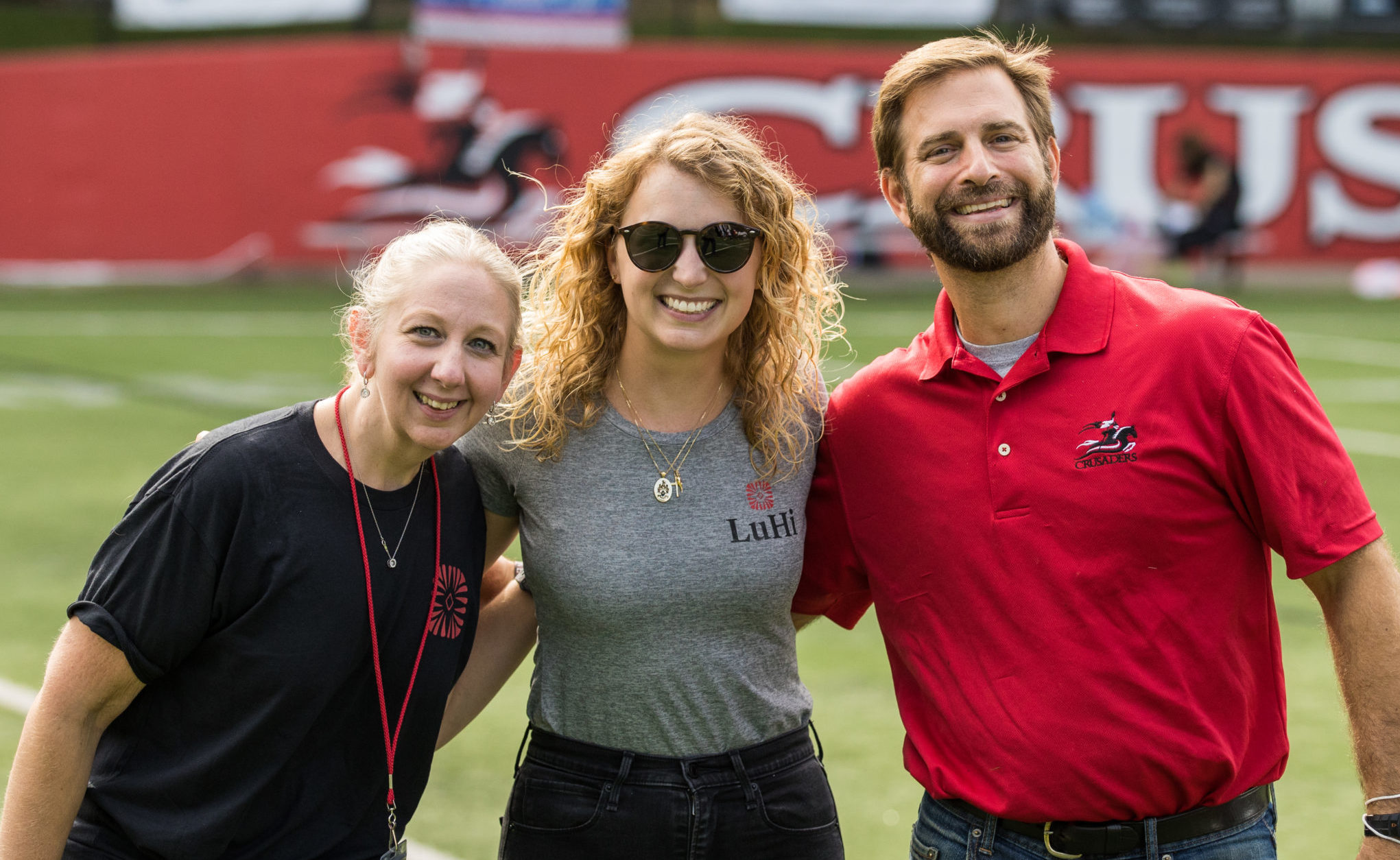 Three LuHi teachers smiling at pep rally