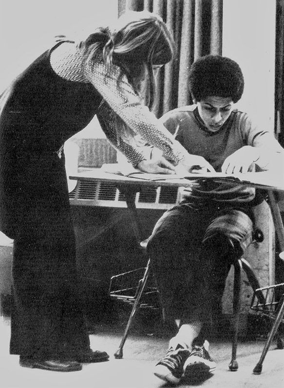 Teacher working one-on-one with student in 1970s