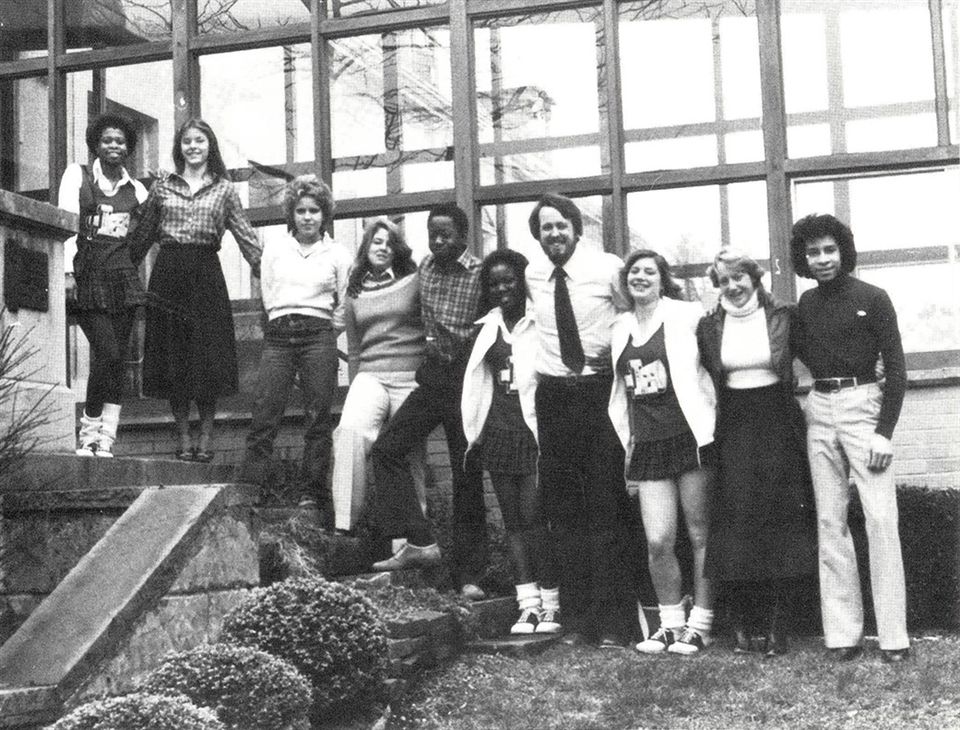 Group of students standing in outside of the school building in the 1980s