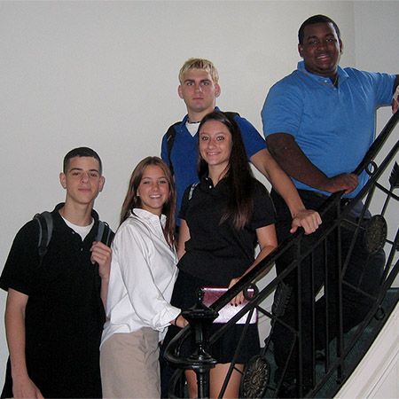 Group of students on the stairs in the mansion in the early 2000s