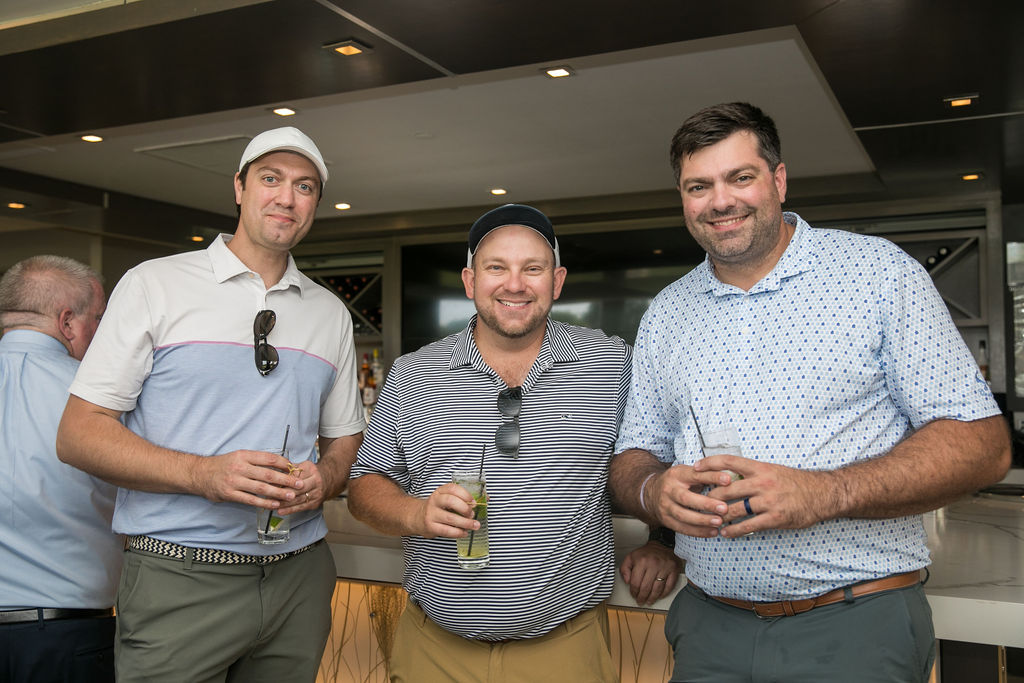 men smiling enjoying drinks at golf outing