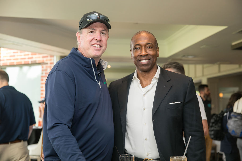 men smiling enjoying drinks at golf outing