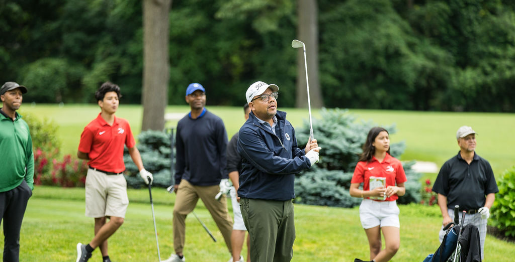 Golfer hitting ball off tee