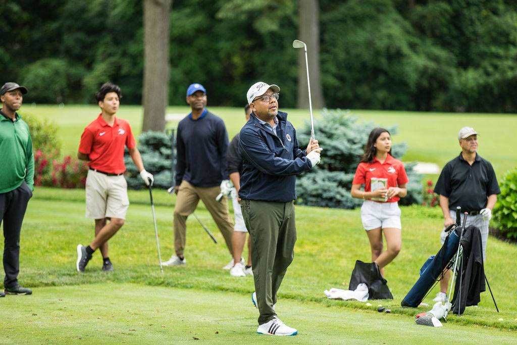 Golfer hitting ball off tee