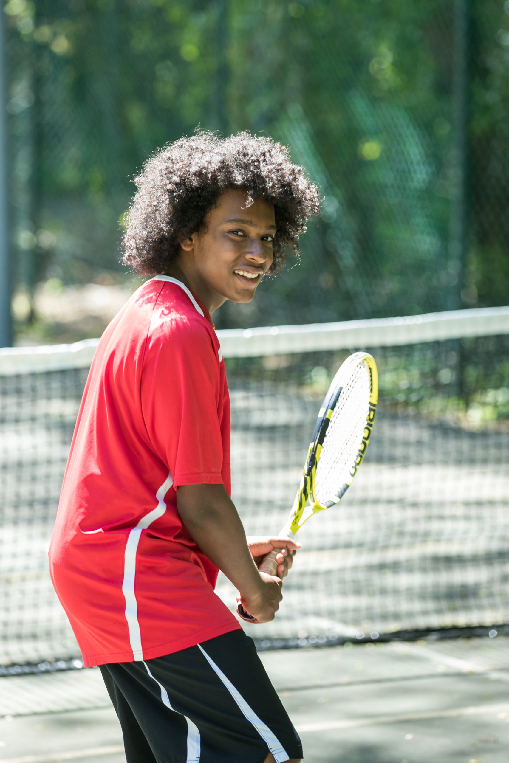boys tennis player posing with racket