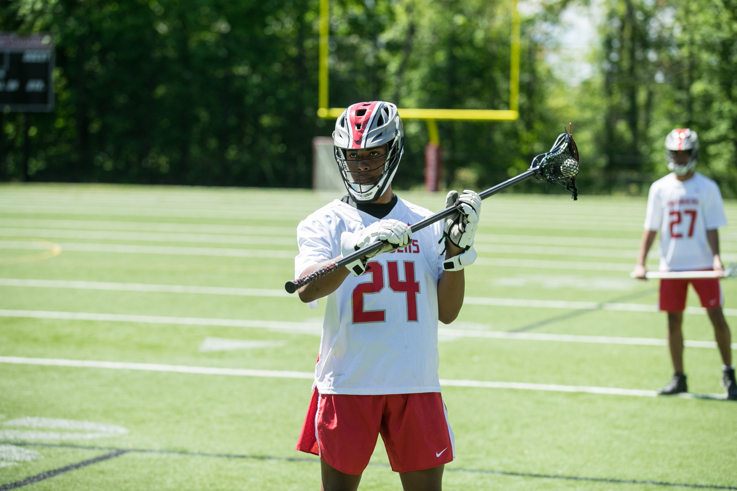 boys lacrosse player with lacrosse stick