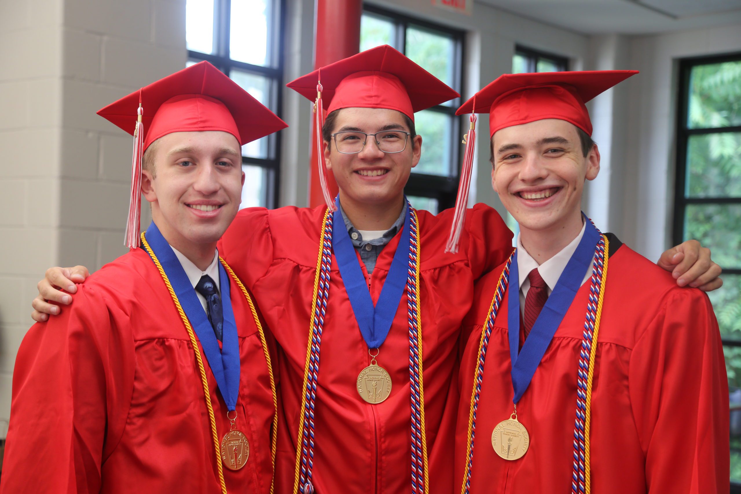 three graduates on graduation