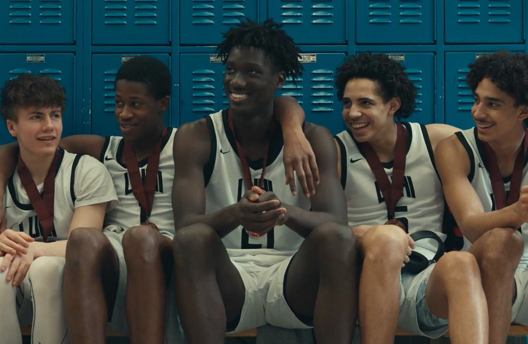 luhi boys basketball team in locker room smiling