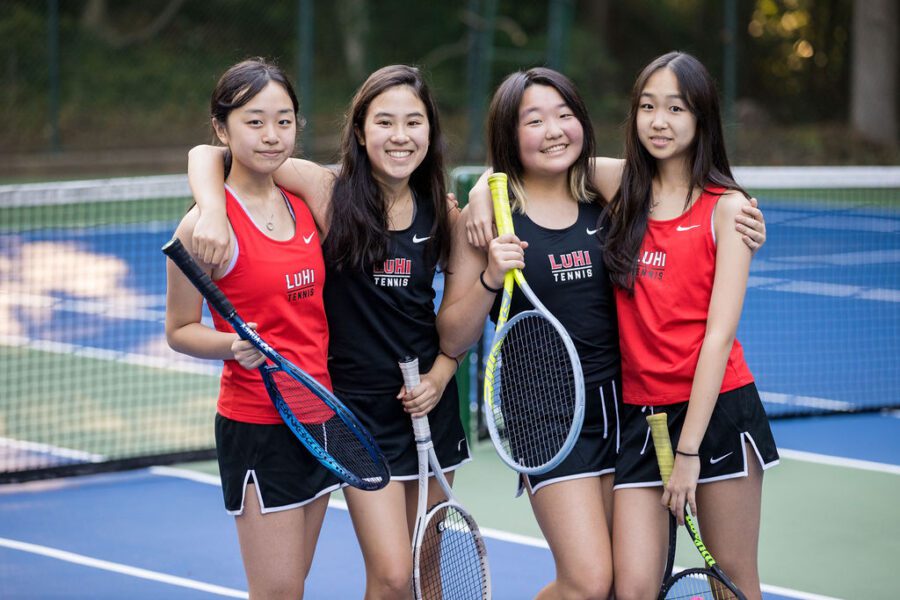 girls tennis players smiling for picture