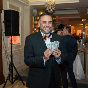 man smiling holding money