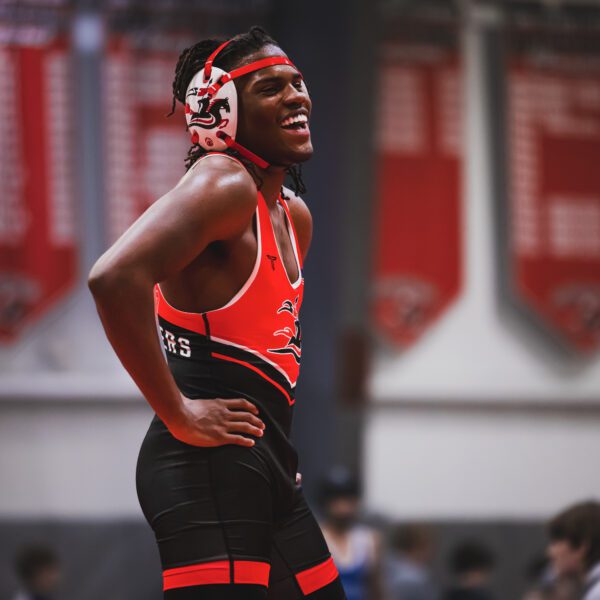 Crusader wrestling player smiling with hands on hip