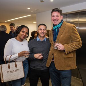 group of three people posing for picture