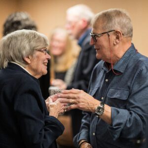 man and woman talking and laughing at event