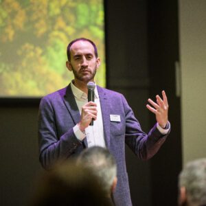 John Buck speaking at event