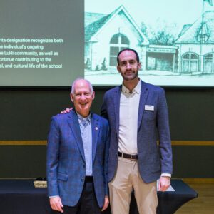 John Buck posing for picture with award recipient