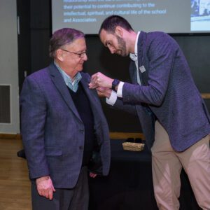 John Buck posing with award recipient