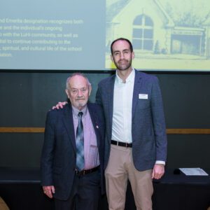John Buck posing for picture with award recipient