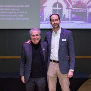 John Buck posing for picture with award recipient