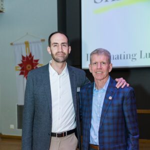 John Buck posing with award recipient