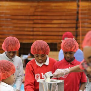 Students packing meals together during the meal packing event